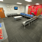 Large patient waiting area with grey and blue chairs surrounding a low center table, featuring carpet flooring and a red Prime Smile wall art logo