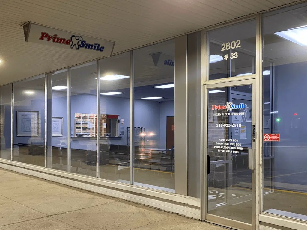 Storefront entrance of Prime Smile suite 33 located at 2802 Lafayette Road, displaying glass windows and operating hours